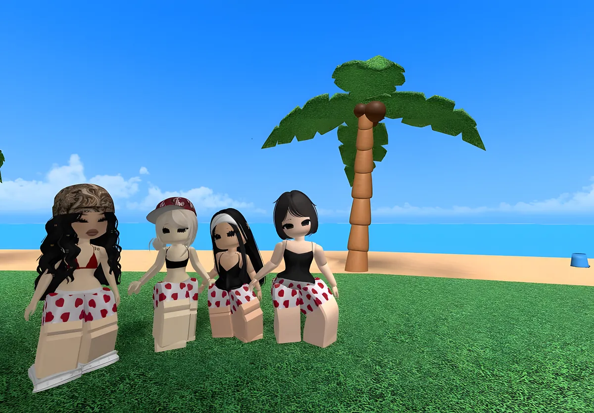 Four friends in matching heart-print shorts on a beach